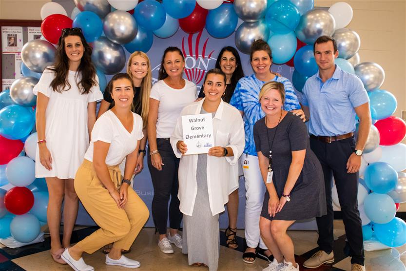 A group of teachers smile